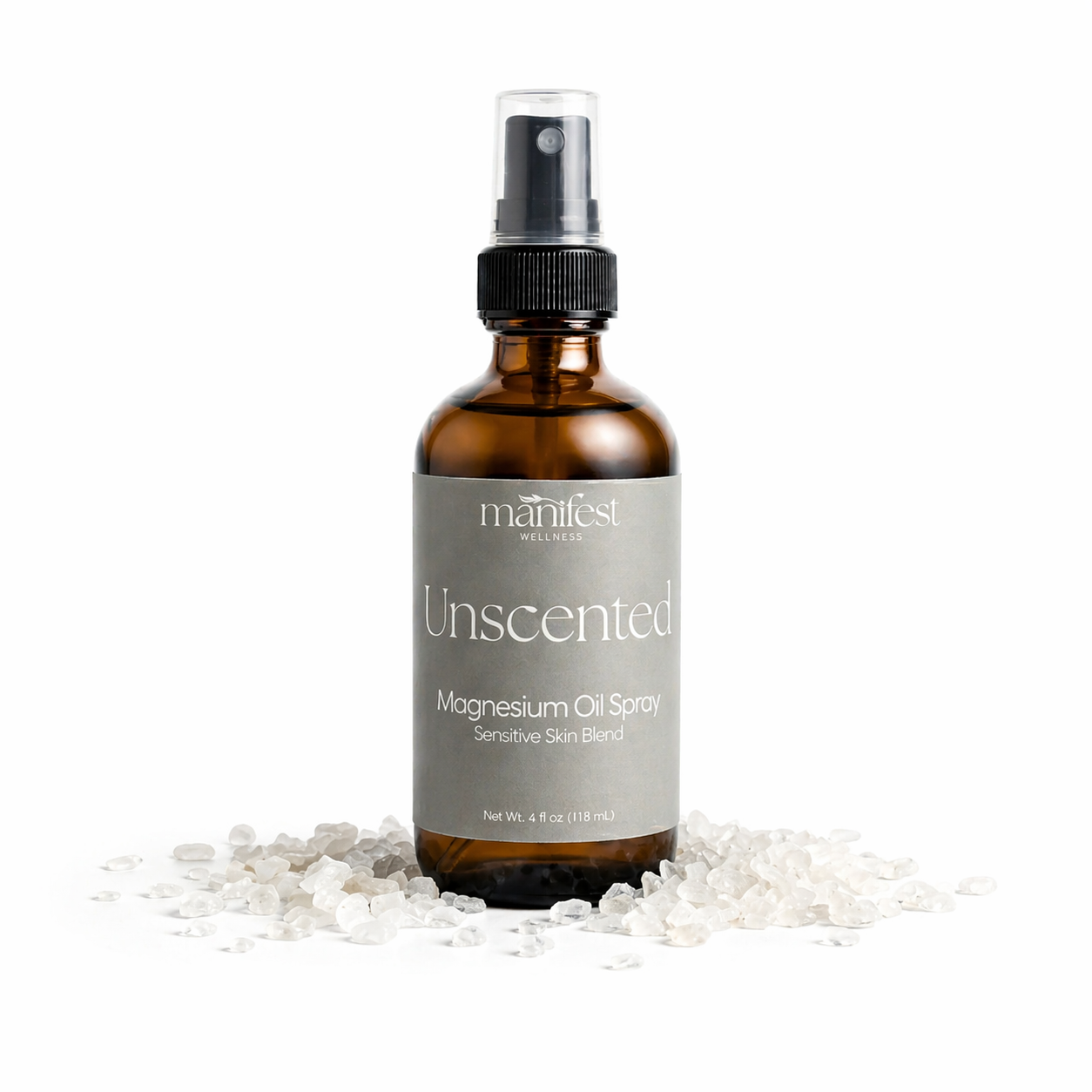 Brown spray bottle labeled Unscented Magnesium Spray by manifest wellness on a white background with magnesium chloride flakes.