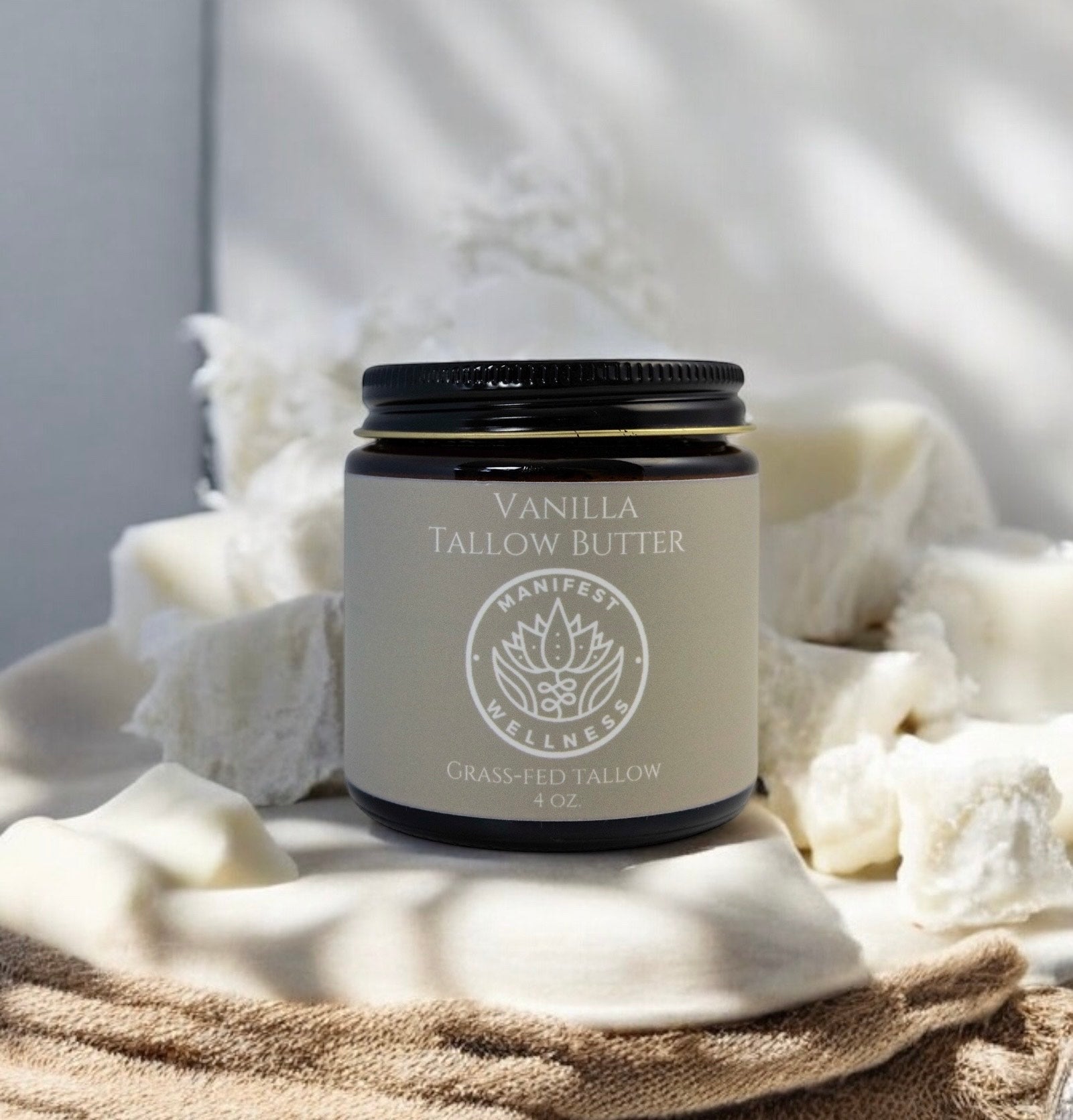 Vanilla Tallow butter in a 4 oz amber glass jar with a black metal lid.