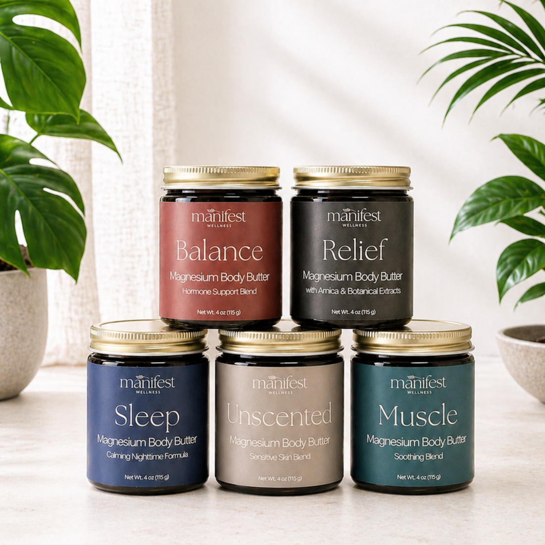 Five jars of Manifest magnesium body butter on a light surface with plants in the background.