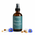 Bottle of Muscle Magnesium Oil Spray by manifest wellness on a white background with blue tansey flowers and frankincense on a white background