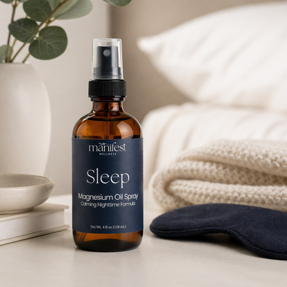 Sleep magnesium oil spray bottle by manifest wellness on a neutral background with a eye mask and plant.