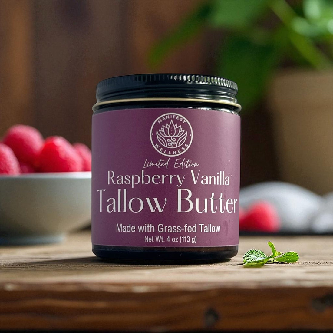 A jar of Raspberry Vanilla Tallow butter in an amber glass jar with a black lid.