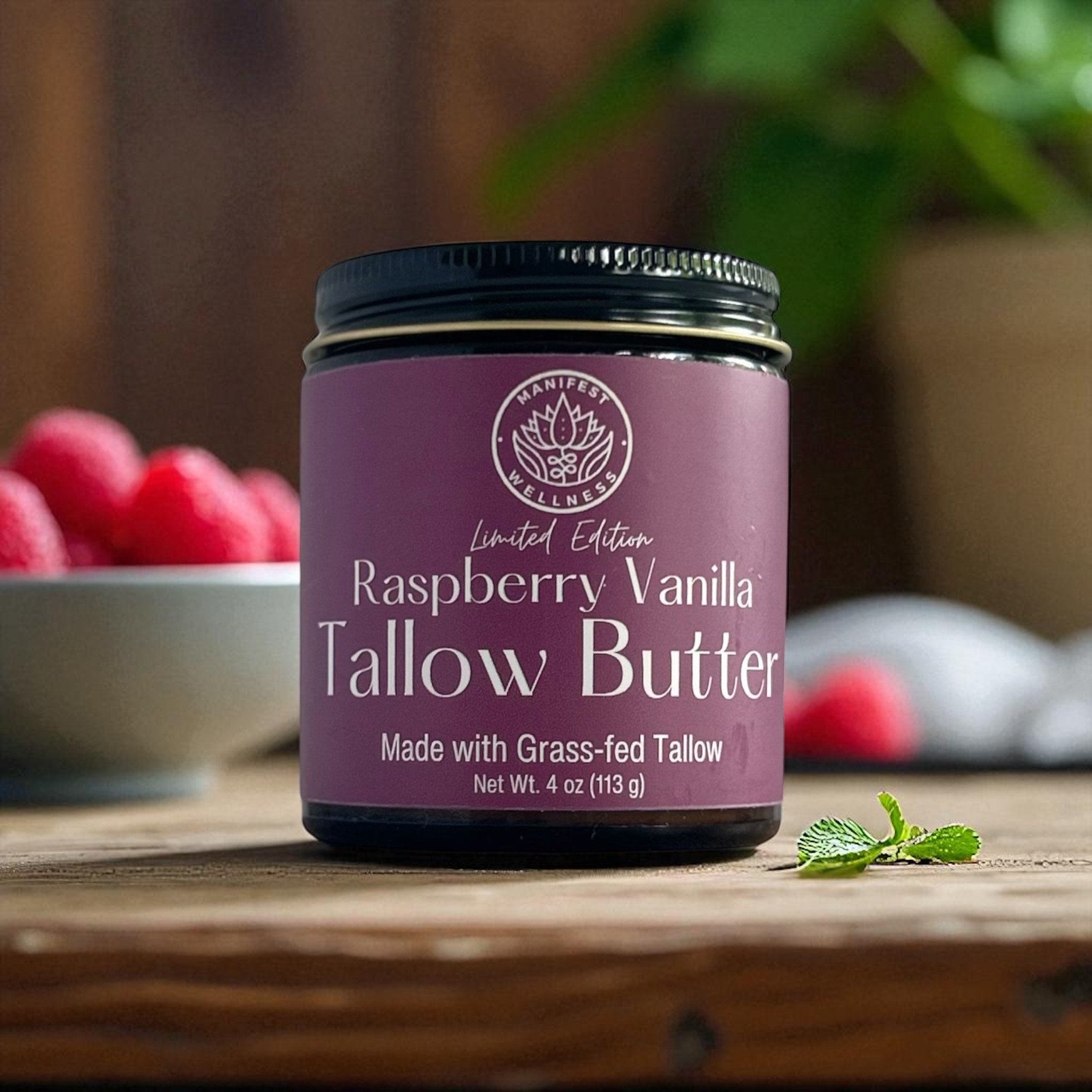 A jar of Raspberry Vanilla Tallow butter in an amber glass jar with a black lid.