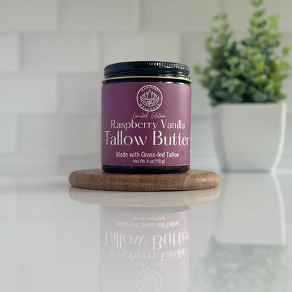 A jar of Raspberry Vanilla Tallow butter in an amber glass jar with a black lid.