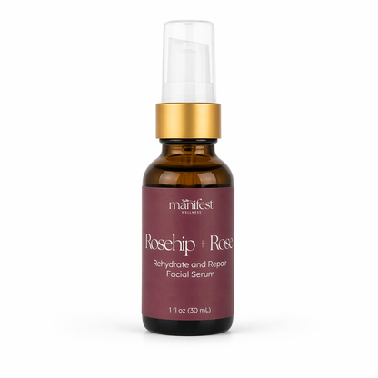 An amber bottle of Rosehip and Rose Serum by Manifest Wellness with gold cap and maroon label on a white background
