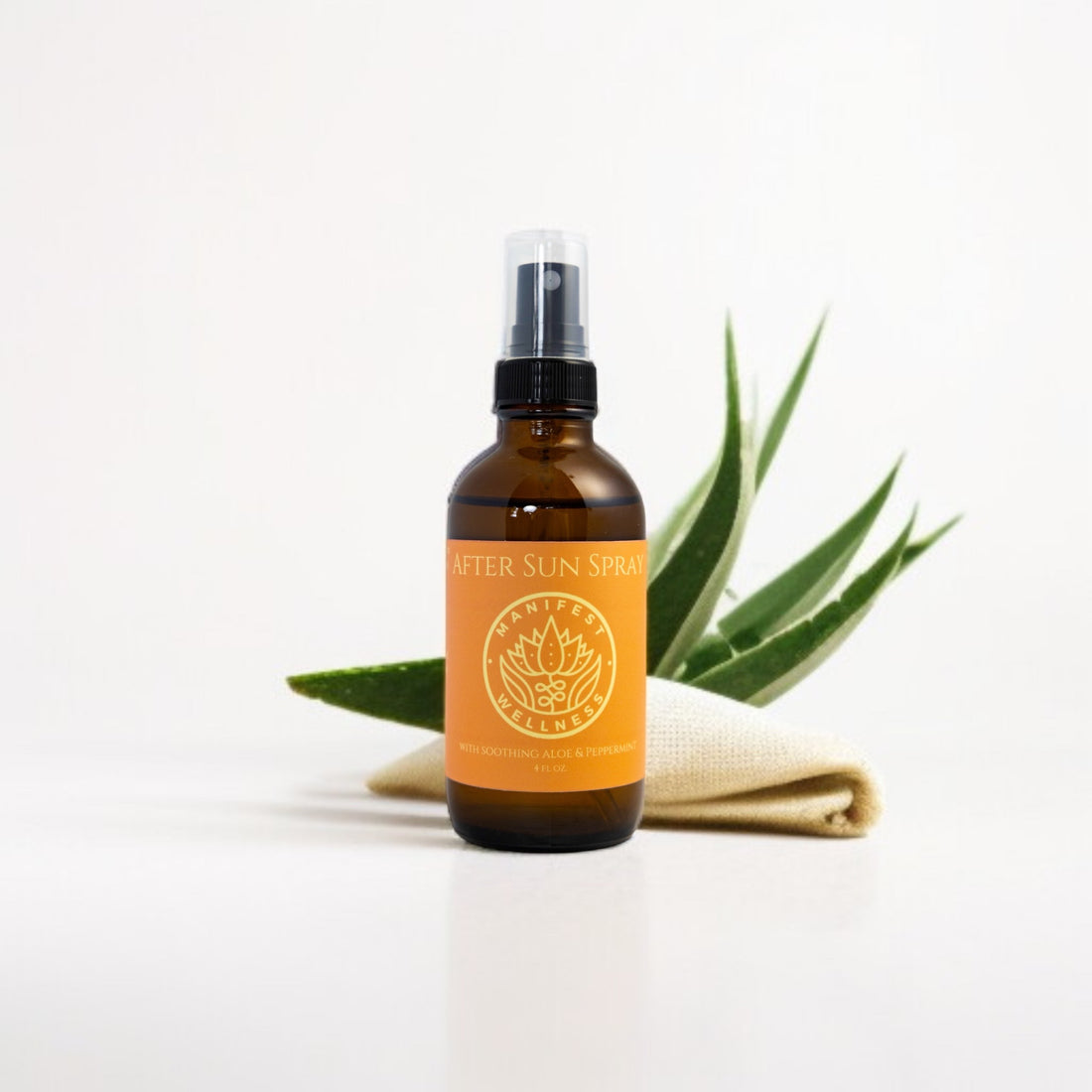Bottle of after sun spray in a glass bottle with aloe vera leaves on a white background