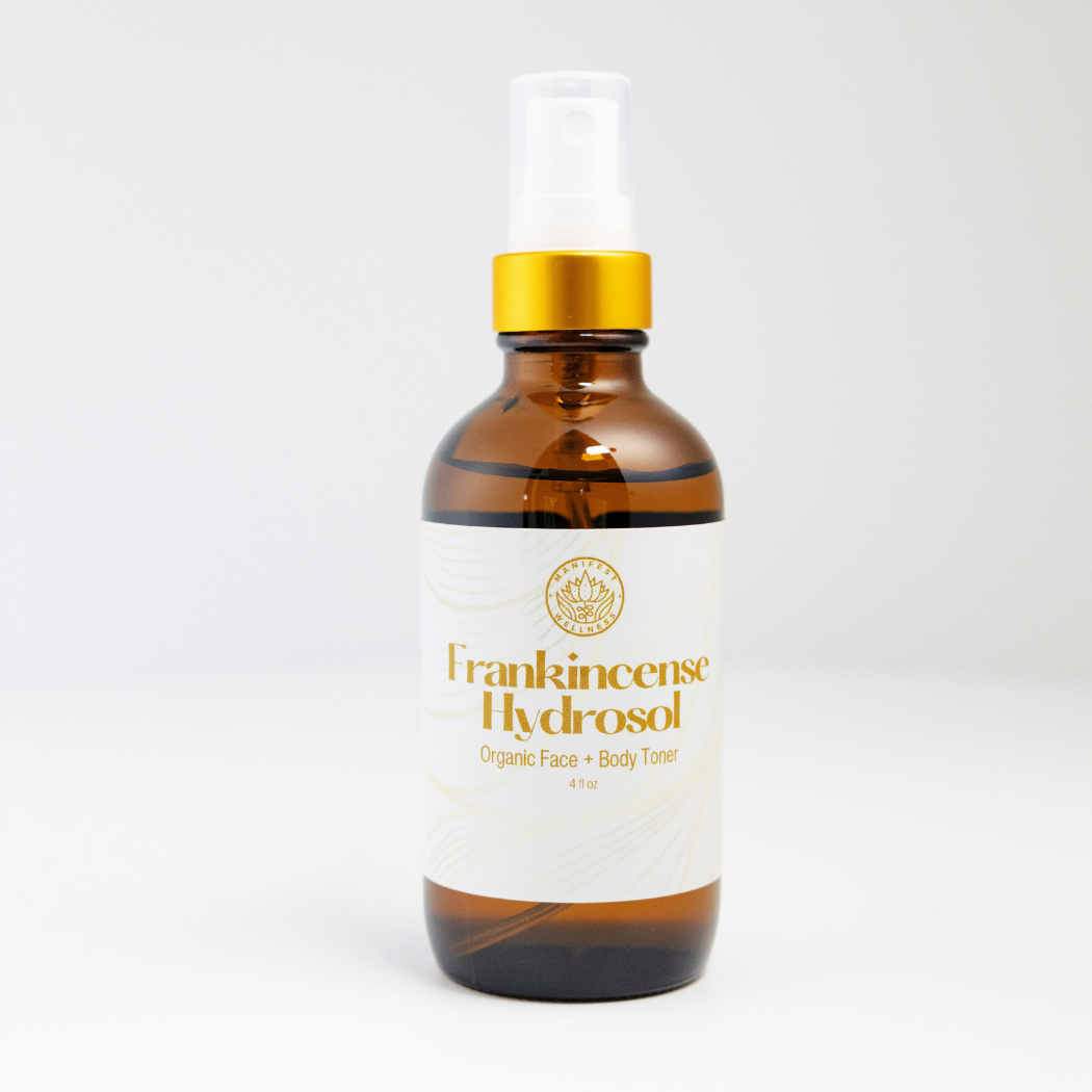 A 4oz amber glass bottle of Frankincense Hydrosol with a gold spray top.
