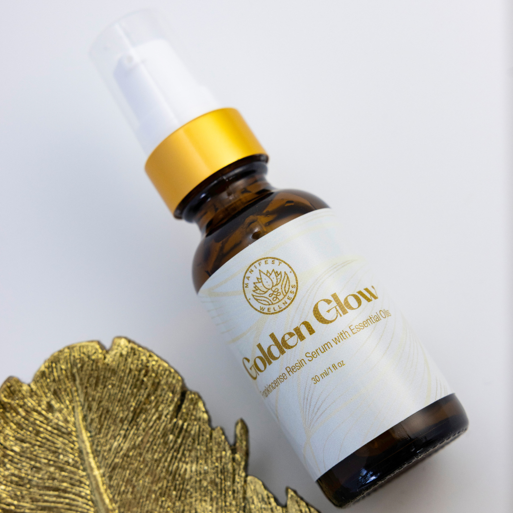 A 1 oz amber glass bottle of Golden Glow Serum with a gold treatment pump lid.