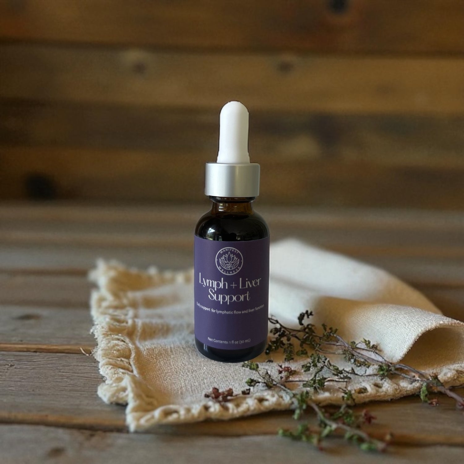 A 1oz amber glass dropper bottle with a white lid of Lymph and Liver Support Tincture