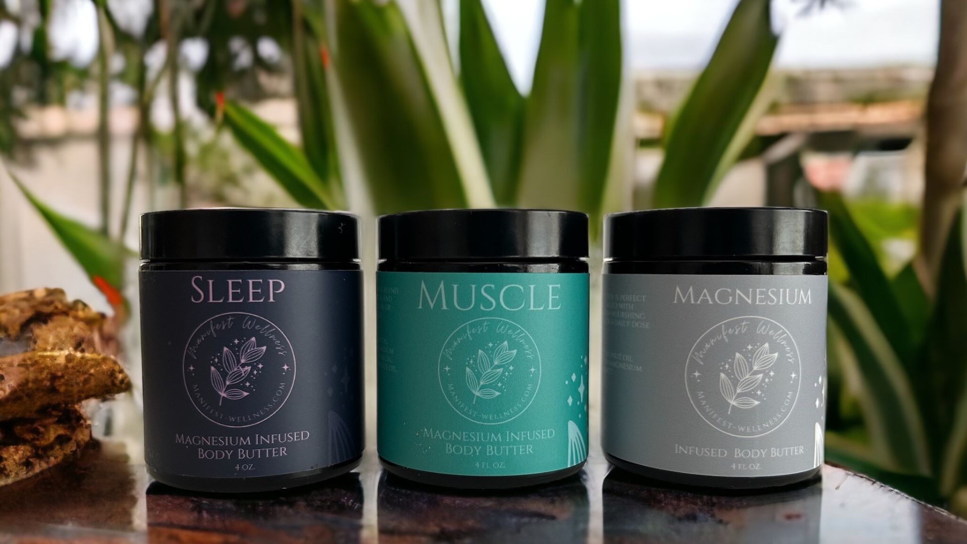 Three Magnesium Body Butter Options. Sleep Butter, Muscle Butter and Unscented Butter in amber glass jars with black lids.
