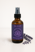 A 4 oz amber glass bottle of Magnesium Sleep Spray with a black sprayer lid.
